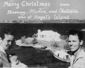 Black and white photo taken in 1955 of Mr. and Mrs. Bronson Hartley, in Bermuda with Harrington sound in the background, with home on angel's island in the center.