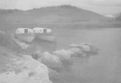 Black and white shot taken by Bronson Hartley in the late 1950's of two 50foot ex-navey boats, destined to become helmet diving vessels to conduct undersea walks in both Nassau, Bahamas, and Bermuda.